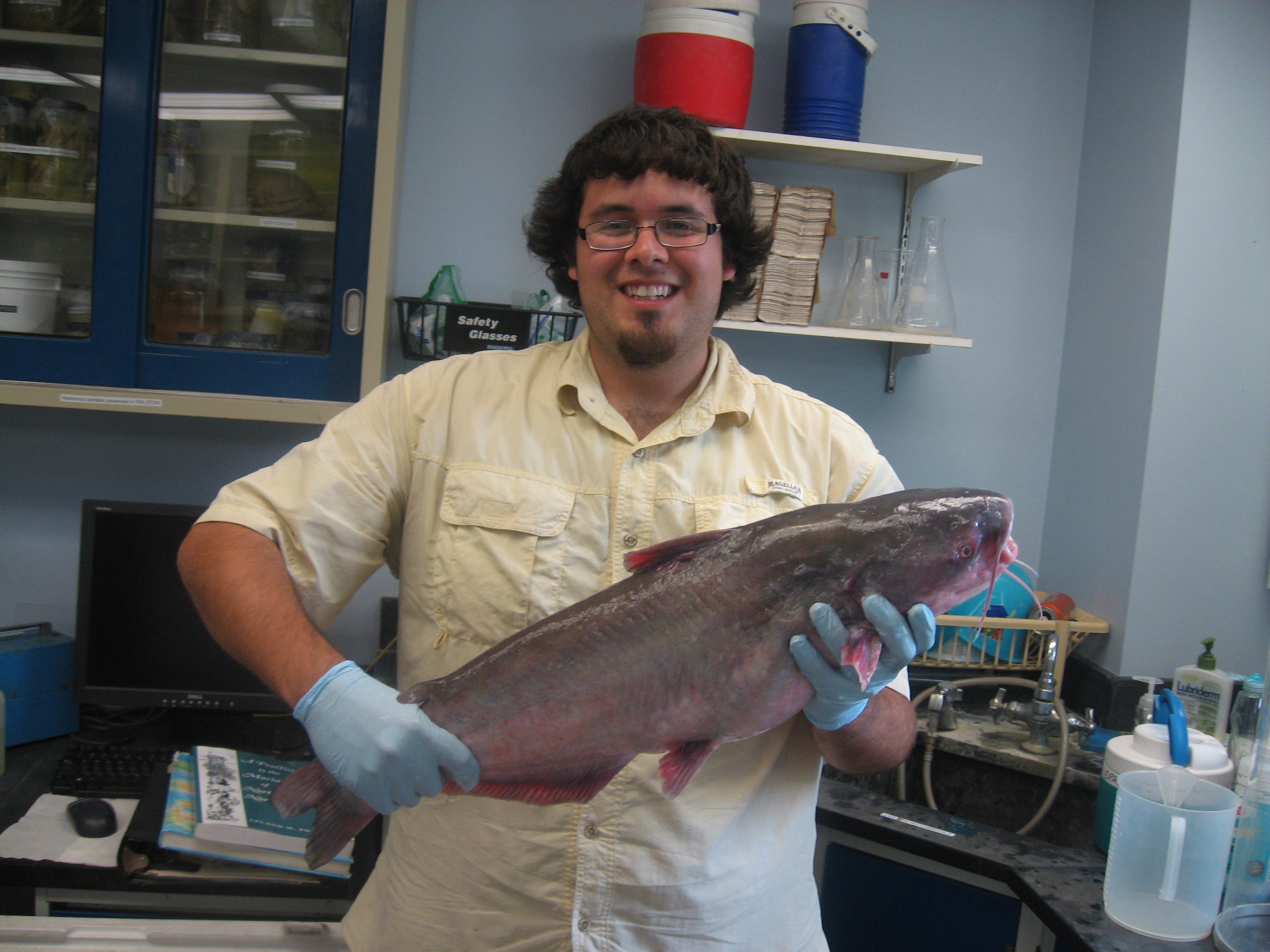 Intern holding catfish