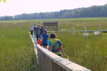 People walking to chambers on boardwalk