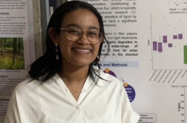 Leona Neftaliem in front of scientific poster