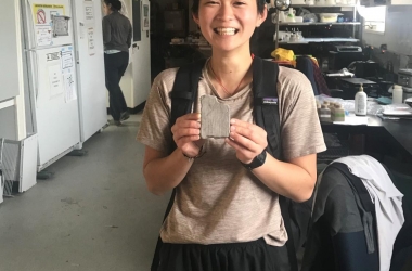 Selina looking excited, holding a rock shaped like Utah