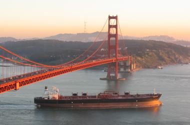 Cargo ship beneath San Francisco bridge