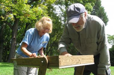 Jim Gibb and volunteer sieve soil