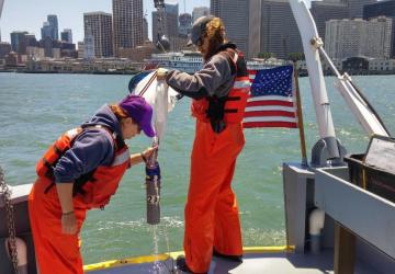 Field crew (Becca & Carl) pulling up a plankton net