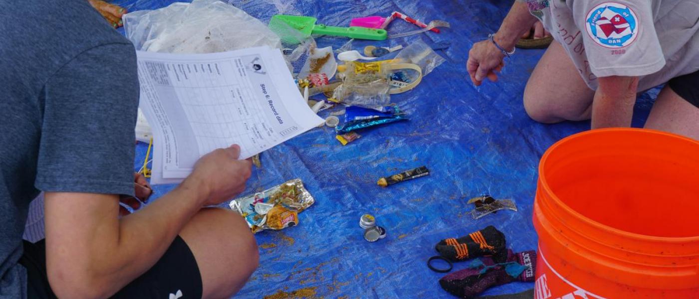 Image of volunteers sorting through marine debris.