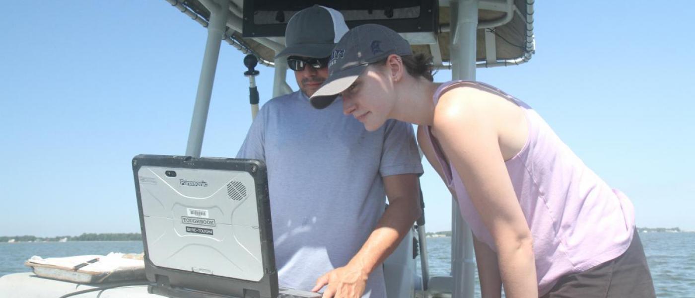 Two researchers looking at computer screen