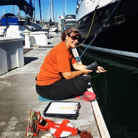 Scientist taking salinity measurements in a marina