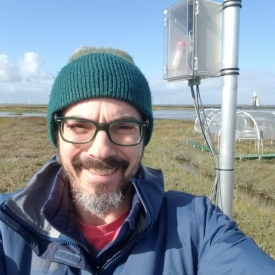 Profile picture of Roy Rich wearing glasses, a green beanie, and a blue jacket